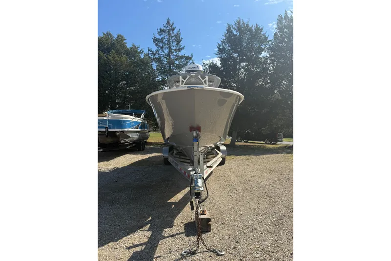 Slide: The Image of 2019 Cape Horn 32 XS boat with dual Suzuki 350 engines, parked outdoors. - 2