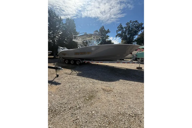 The Image of 2019 Cape Horn 32 XS boat on trailer, parked outside a brick building. - 0