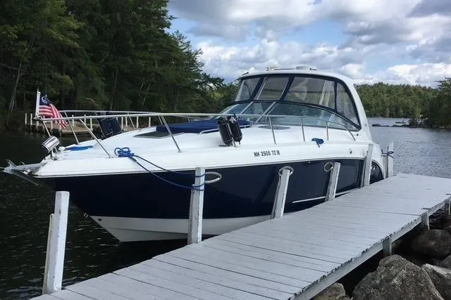 Slide: The Image of 2009 Chaparral Signature 350 docked on a serene lake with lush trees. - 1