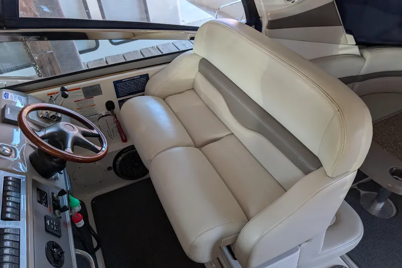 Slide: The Image of 2009 Chaparral Signature 350 boat interior with leather seating and wooden steering wheel. - 12