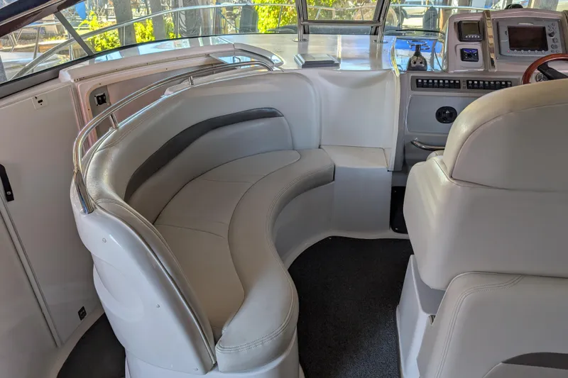 Slide: The Image of Interior of 2009 Chaparral Signature 350 boat with white seating and control panel. - 14