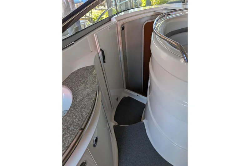 Slide: The Image of 2009 Chaparral Signature 350 boat interior with sink and curved seating area. - 15