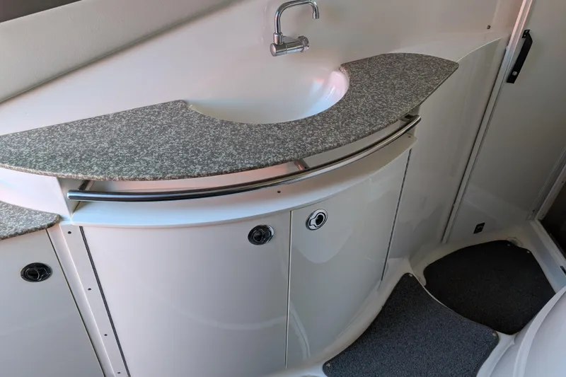Slide: The Image of 2009 Chaparral Signature 350 boat interior with a sleek sink and countertop design. - 16