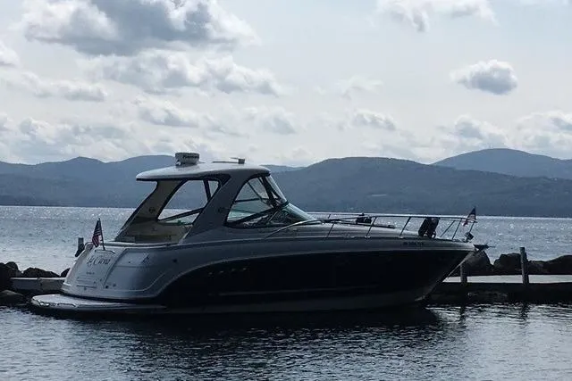 Slide: The Image of 2009 Chaparral Signature 350 boat docked by a scenic lake with mountains. - 2