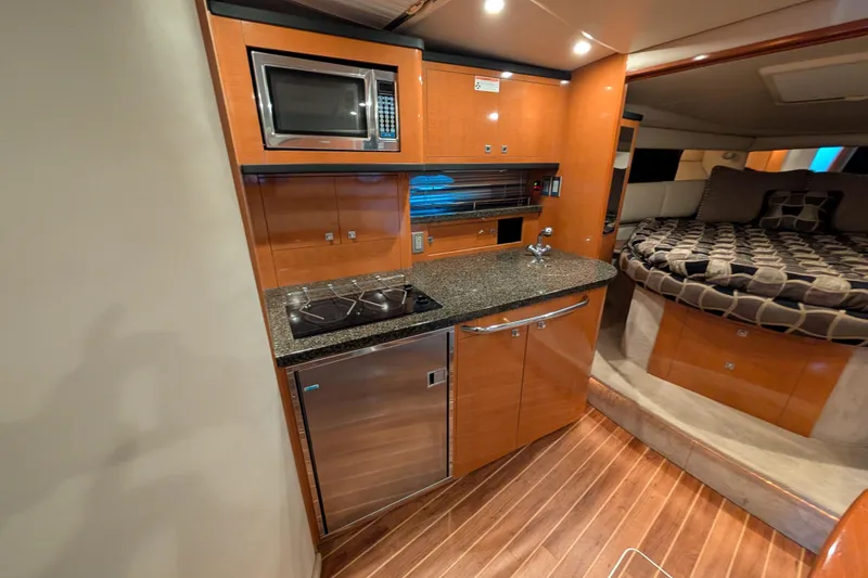 Slide: The Image of 2009 Chaparral Signature 350 yacht interior with kitchenette and cozy sleeping area. - 23