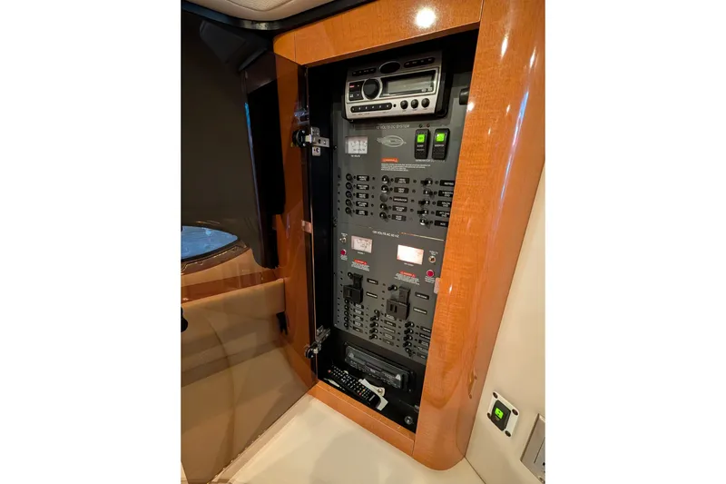 Slide: The Image of Control panel inside 2009 Chaparral Signature 350 boat, featuring various switches and electronic components. - 24