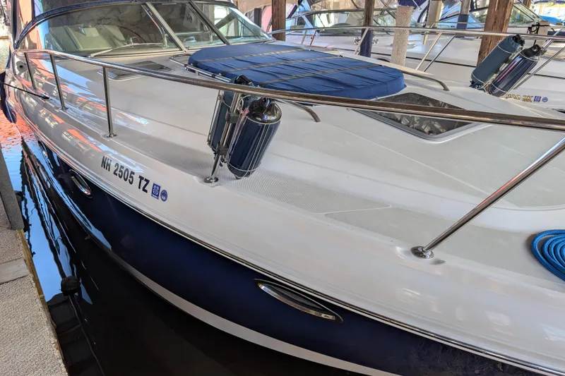 Slide: The Image of 2009 Chaparral Signature 350 boat docked, featuring sleek design and polished railings. - 5