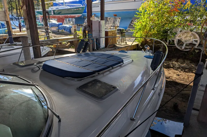 Slide: The Image of 2009 Chaparral Signature 350 boat docked, featuring a sleek deck and sun pad. - 8