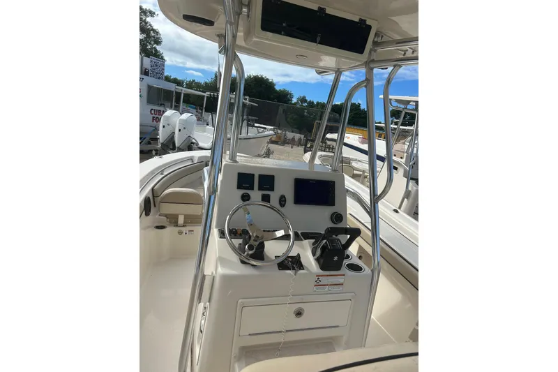 Slide: The Image of 2021 Sea Chaser Carolina Skiff boat console with steering wheel and controls. - 2