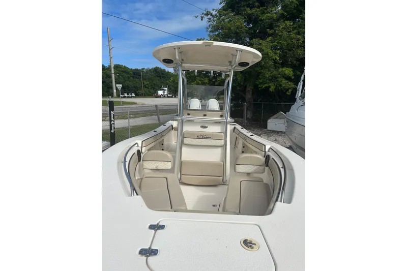 Slide: The Image of 2021 Sea Chaser Carolina Skiff boat with seating and canopy, parked outdoors. - 4