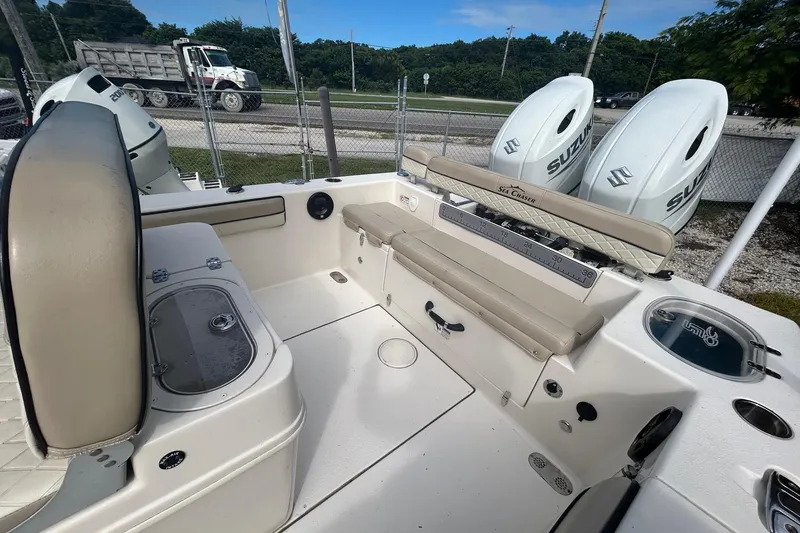Slide: The Image of 2021 Sea Chaser Carolina Skiff boat interior with Suzuki engines, featuring seating and storage. - 5