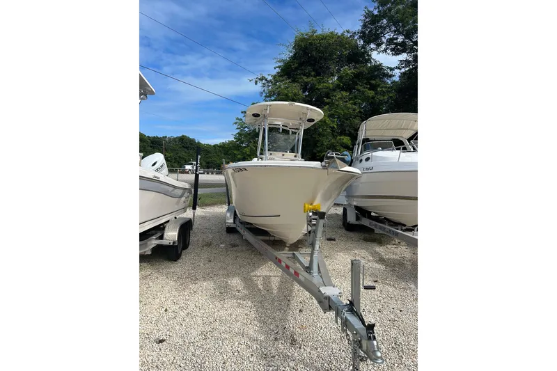 Slide: The Image of 2021 Sea Chaser Carolina Skiff boat on trailer, parked outdoors. - 6