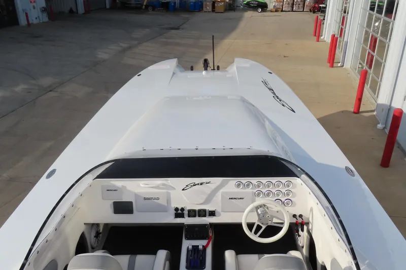 Slide: The Image of 1997 Skater 36 boat with sleek white design and detailed cockpit view. - 10