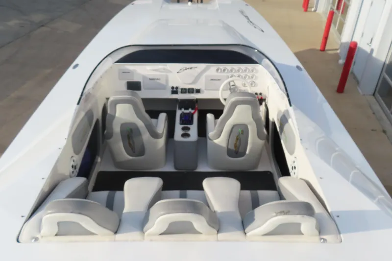 Slide: The Image of 1997 Skater 36 boat interior with white seating and dashboard controls. - 11