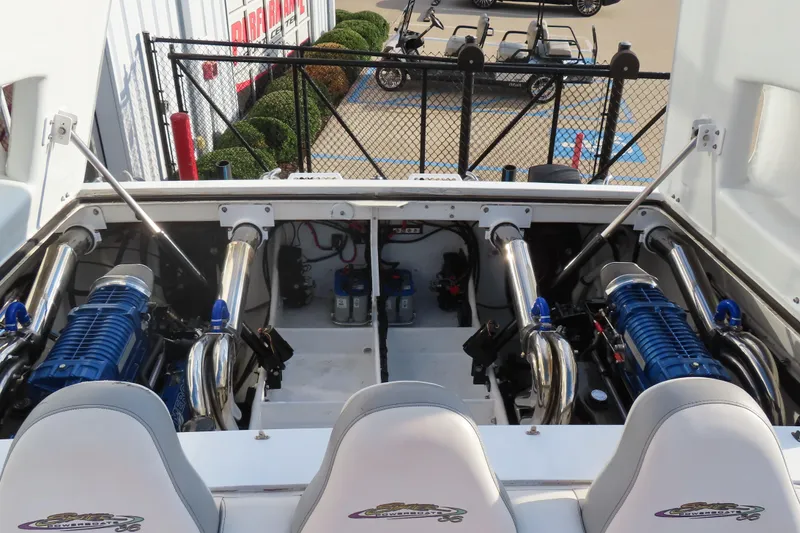 Slide: The Image of Engine compartment of a 1997 Skater 36 boat with dual blue engines. - 13