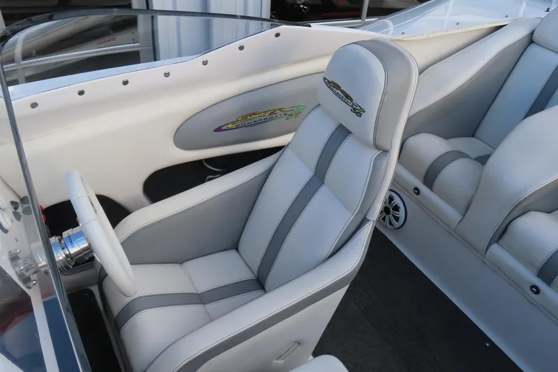 Slide: The Image of Interior of a 1997 Skater 36 boat featuring sleek white and gray seating. - 18
