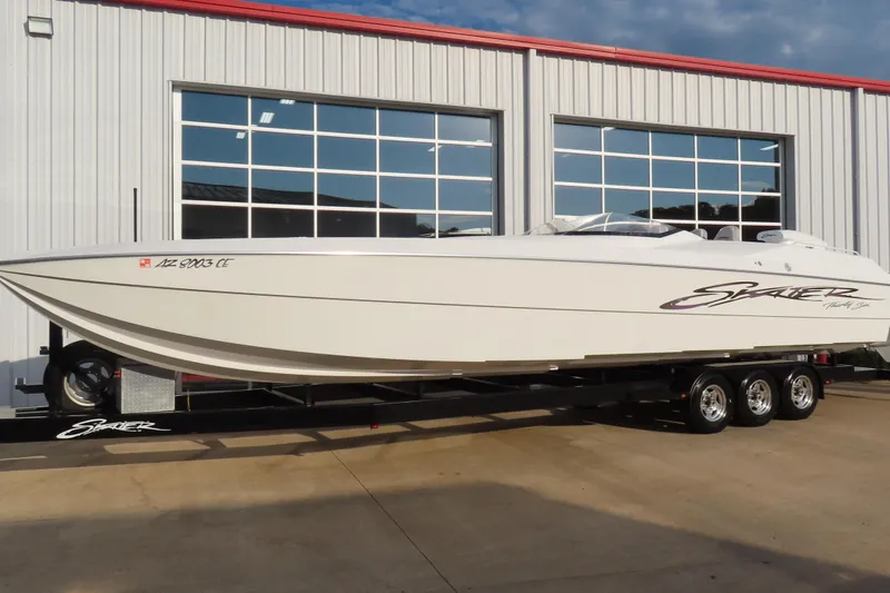 Slide: The Image of 1997 Skater 36 powerboat on trailer outside a garage. - 2