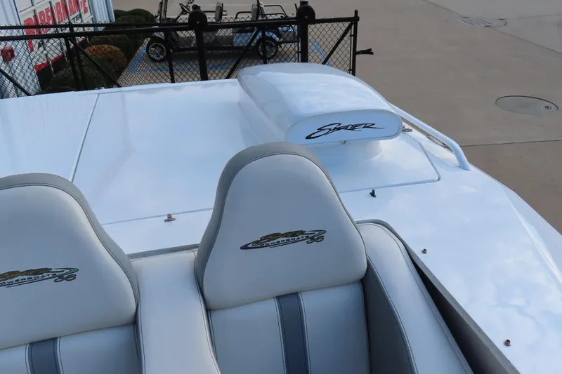 Slide: The Image of 1997 Skater 36 powerboat with white seats and sleek design, parked outdoors. - 21