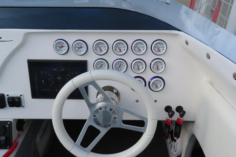 Slide: The Image of 1997 Skater 36 boat dashboard with gauges and steering wheel. - 26