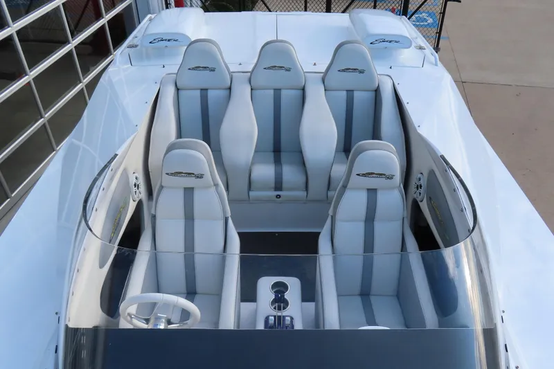 Slide: The Image of 1997 Skater 36 boat interior with four gray and white seats, steering wheel, and dashboard. - 28