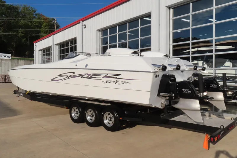 Slide: The Image of 1997 Skater 36 powerboat on trailer, parked outside a garage. - 4