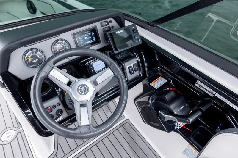 Slide: The Image of 2017 Yamaha Boats SX210 dashboard with steering wheel and control panel. - 11