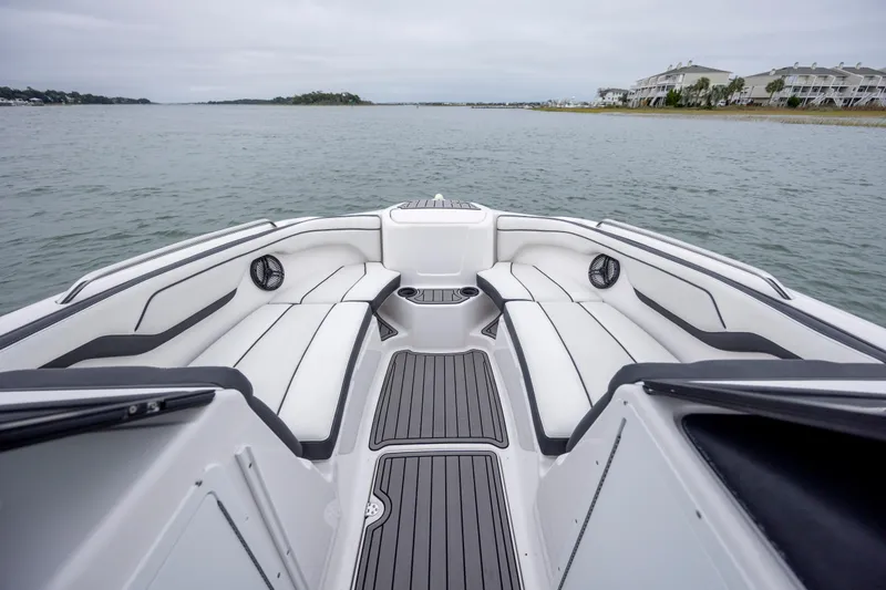 Slide: The Image of 2017 Yamaha Boats SX210 interior with sleek seating and waterfront view. - 12
