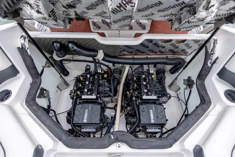 Slide: The Image of 2017 Yamaha Boats SX210 engine compartment with dual engines and visible wiring. - 17