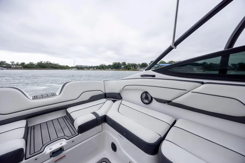 Slide: The Image of 2017 Yamaha Boats SX210 interior with sleek seating and water view. - 7