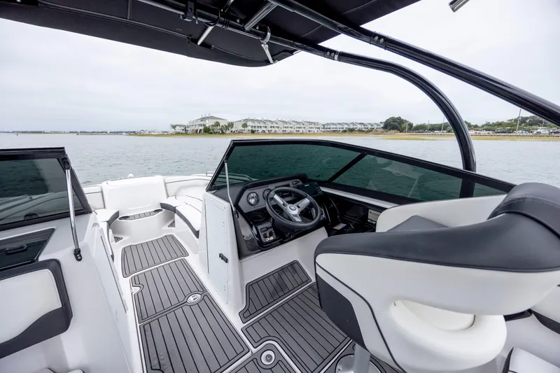 Slide: The Image of 2017 Yamaha Boats SX210 interior with steering wheel, seating, and water view. - 9