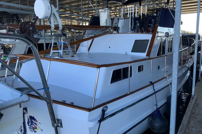 Slide: The Image of 1976 Cheoy Lee 40 LRC yacht docked in a marina, featuring classic design elements. - 11