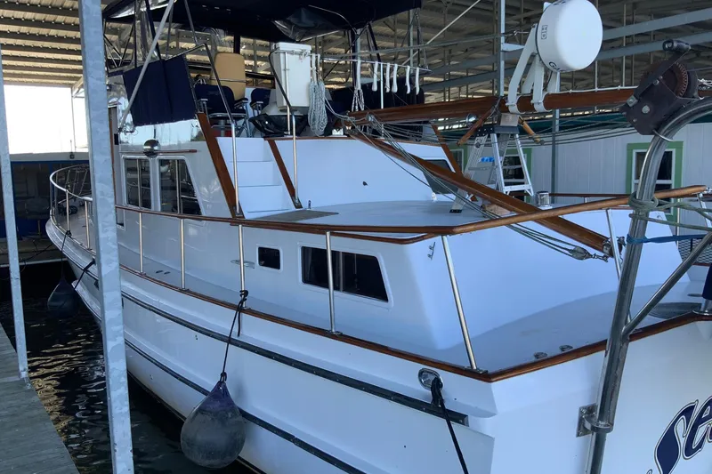 Slide: The Image of 1976 Cheoy Lee 40 LRC yacht docked in a covered marina. - 12