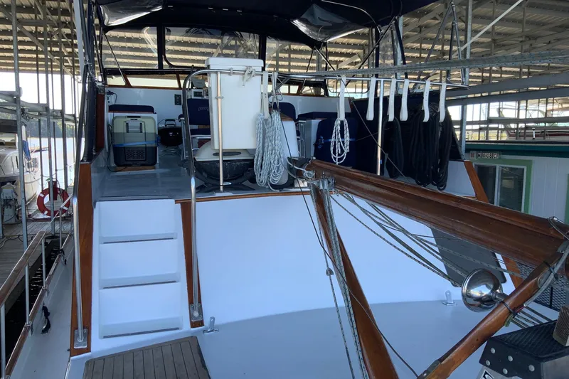 Slide: The Image of 1976 Cheoy Lee 40 LRC yacht interior with ropes and equipment in a marina. - 13