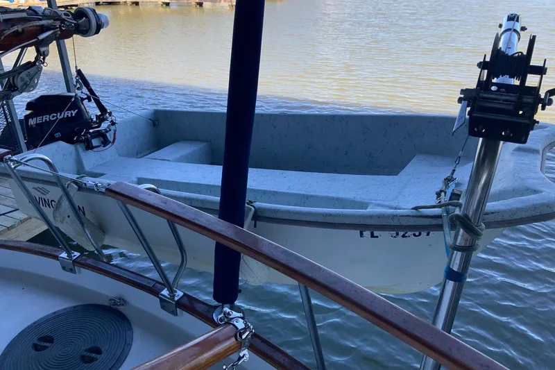 Slide: The Image of 1976 Cheoy Lee 40 LRC boat with Mercury outboard motor docked by the water. - 23