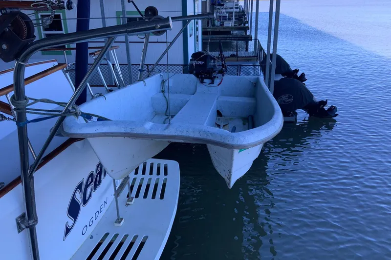 Slide: The Image of 1976 Cheoy Lee 40 LRC yacht with attached dinghy at dockside. - 24