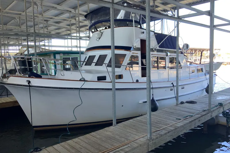 Slide: The Image of 1976 Cheoy Lee 40 LRC yacht docked in a covered marina. - 3