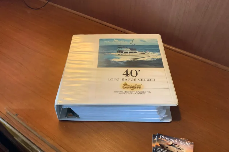 Slide: The Image of Binder for 1976 Cheoy Lee 40 LRC Long Range Cruiser on wooden table. - 33