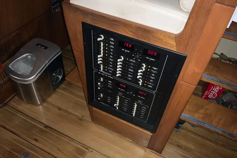 Slide: The Image of Electrical panel on 1976 Cheoy Lee 40 LRC yacht, wooden interior, adjacent trash bin. - 36