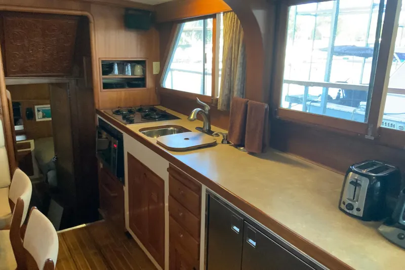 Slide: The Image of 1976 Cheoy Lee 40 LRC yacht kitchen with wooden cabinetry and modern appliances. - 39