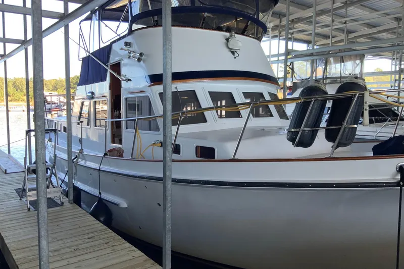 Slide: The Image of 1976 Cheoy Lee 40 LRC yacht docked in a covered marina. - 4
