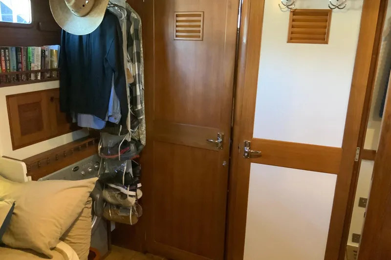 Slide: The Image of Interior of 1976 Cheoy Lee 40 LRC with wooden doors and hanging clothes. - 40