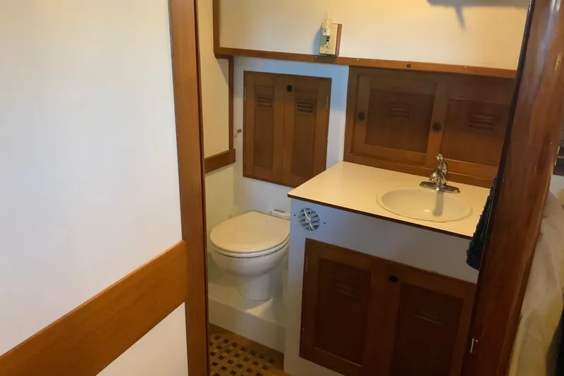 Slide: The Image of 1976 Cheoy Lee 40 LRC yacht bathroom with wooden cabinets and white sink. - 45