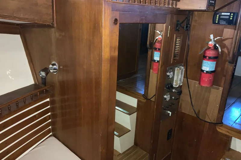 Slide: The Image of 1976 Cheoy Lee 40 LRC yacht interior with wood paneling and safety equipment. - 47