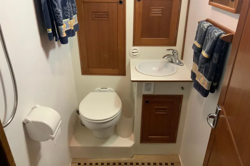 Slide: The Image of 1976 Cheoy Lee 40 LRC yacht bathroom with wooden cabinets and nautical-themed towels. - 48