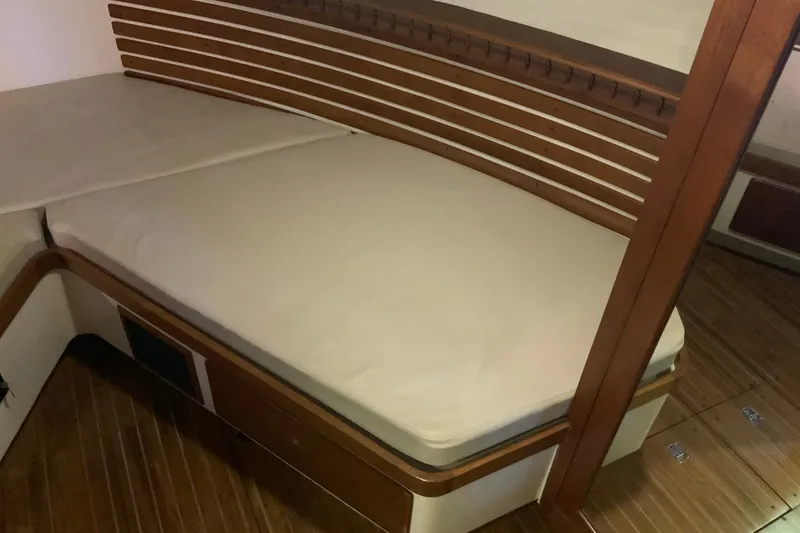 Slide: The Image of 1976 Cheoy Lee 40 LRC interior cabin with wooden accents and cushioned bed. - 50