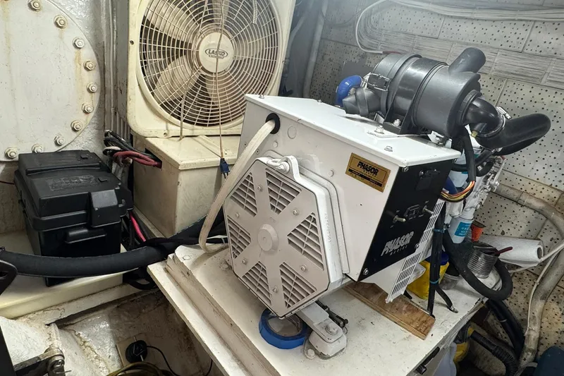 Slide: The Image of Engine room of 1976 Cheoy Lee 40 LRC with generator and fan. - 52