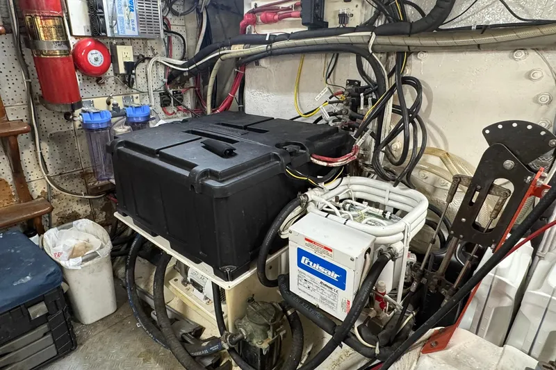 Slide: The Image of Engine room of 1976 Cheoy Lee 40 LRC yacht with mechanical equipment and wiring. - 53