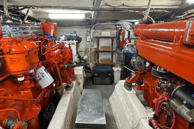 Slide: The Image of Engine room of a 1976 Cheoy Lee 40 LRC with vibrant orange machinery. - 56