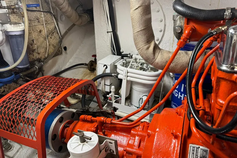 Slide: The Image of Engine room of a 1976 Cheoy Lee 40 LRC yacht with visible machinery and pipes. - 61