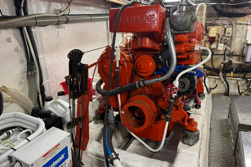 Slide: The Image of Engine room of a 1976 Cheoy Lee 40 LRC with red marine engine. - 62